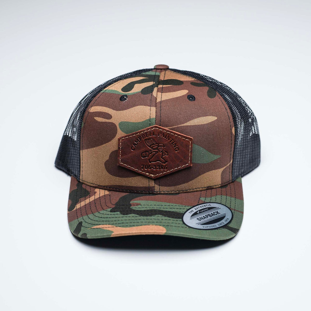 Debossed Heat Pressed - Yupoong 6606 Cap Leather Patch Camo Trucker Hat with YOUR LOGO