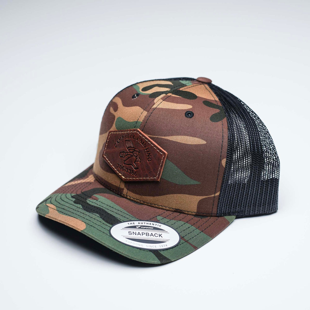 Debossed Heat Pressed - Yupoong 6606 Cap Leather Patch Camo Trucker Hat with YOUR LOGO