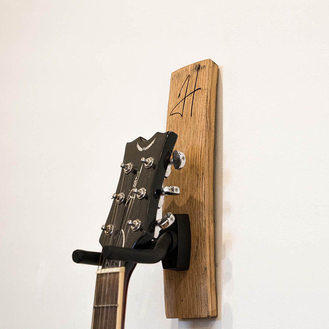 Guitar holder made of Tennessee Whiskey Barrel with personalized name and handcrafted at Holtz Leather Co