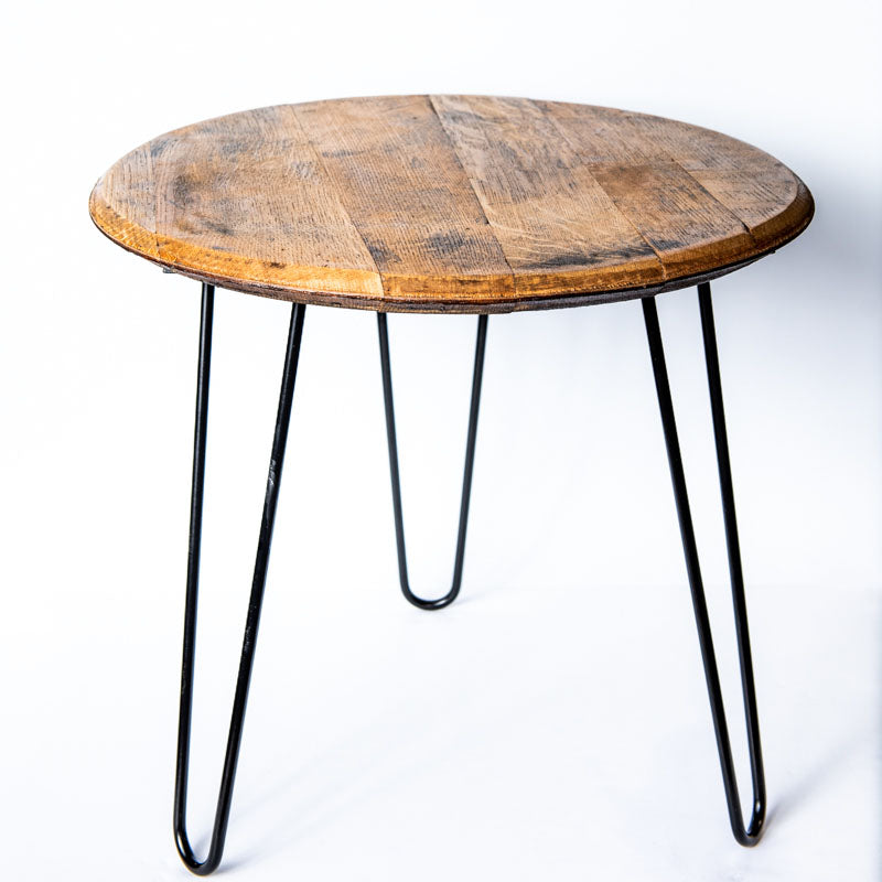 Side table made of Tennessee Whiskey Barrel wood with a potted plant sitting on top of it