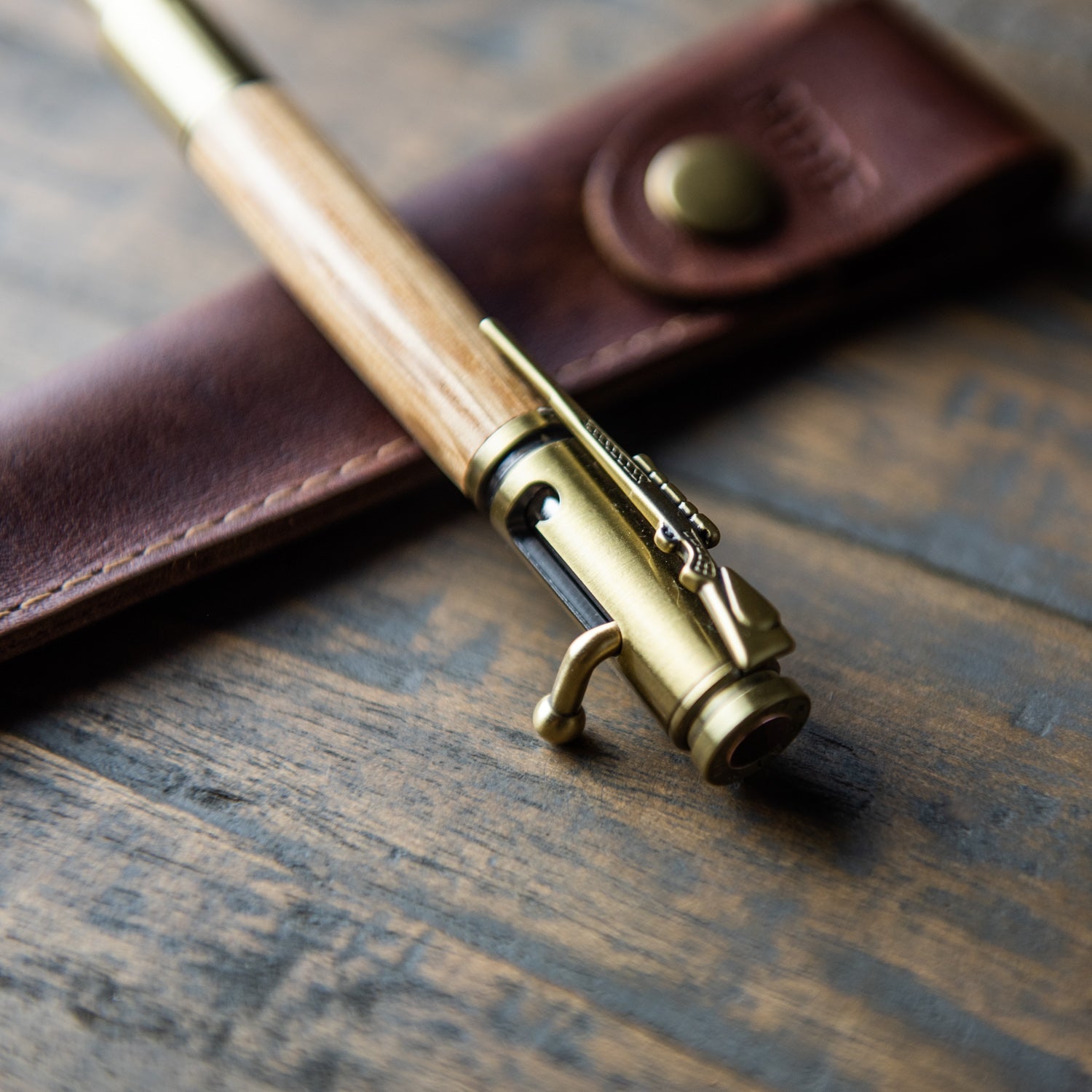 .30 caliber bolt action pen made of Tennessee Whiskey Barrel wood with a personalized leather pen sleeve 